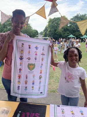 Mum and daughter with tea towel at school fete